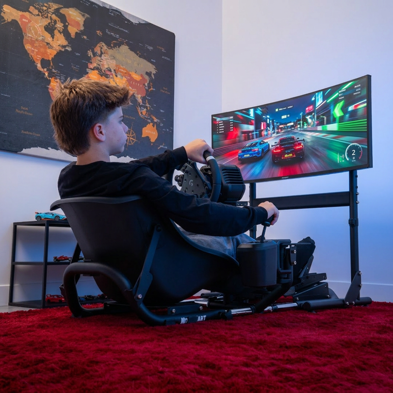Young driver using NitroKart cockpit with monitor stand setup, gaming room lifestyle photo